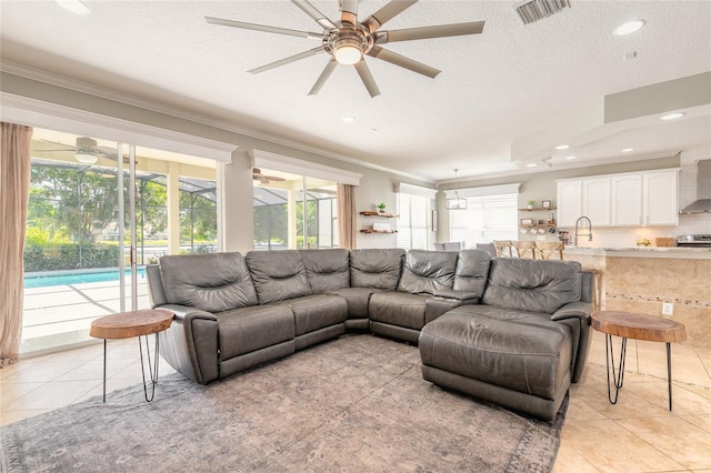 495 Venetian Villa Dr, New Smyrna Beach, FL 32168 - living area with a healthy amount of sunlight, light tile patterned floors, crown molding, and ceiling fan