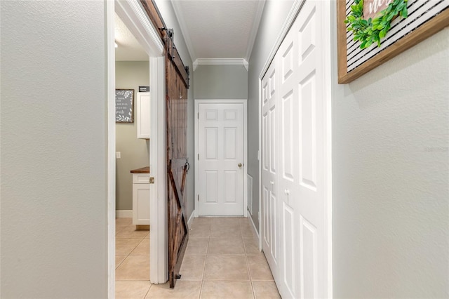 495 Venetian Villa Dr, New Smyrna Beach, FL 32168 - hall featuring crown molding, a barn door, and light tile patterned flooring