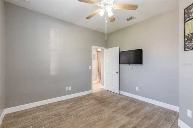 495 Venetian Villa Dr, New Smyrna Beach, FL 32168 - unfurnished room with visible vents, baseboards, ceiling fan, and wood finished floors