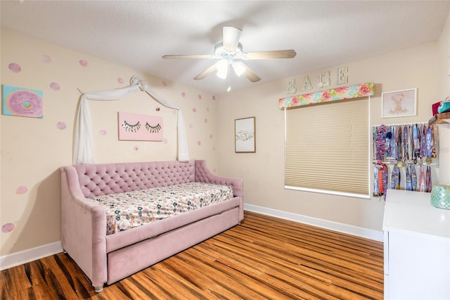 495 Venetian Villa Dr, New Smyrna Beach, FL 32168 - bedroom with baseboards, a ceiling fan, and wood finished floors
