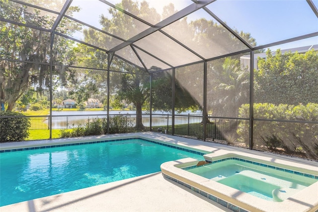 495 Venetian Villa Dr, New Smyrna Beach, FL 32168 - view of swimming pool with a water view, a pool with connected hot tub, a lanai, and fence
