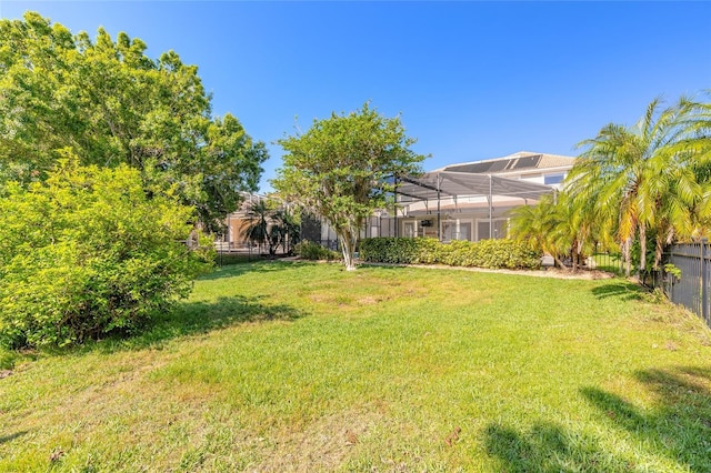 495 Venetian Villa Dr, New Smyrna Beach, FL 32168 - view of yard with fence and glass enclosure