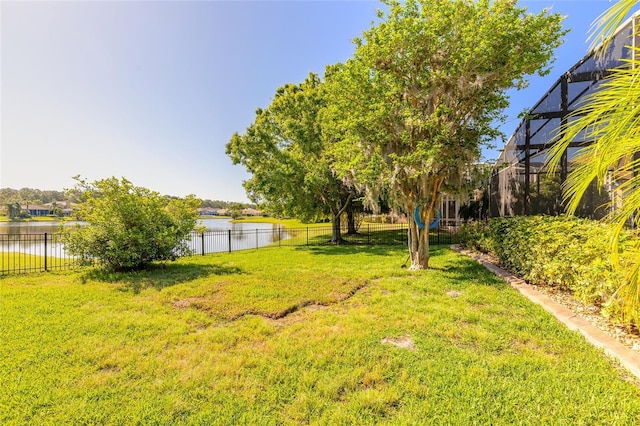 495 Venetian Villa Dr, New Smyrna Beach, FL 32168 - view of yard featuring a water view, a lanai, and fence