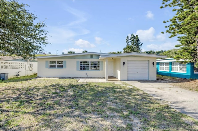 915 E 2nd Ave, New Smyrna Beach, FL 32169 - ranch-style home featuring an attached garage, fence, a front lawn, and concrete driveway