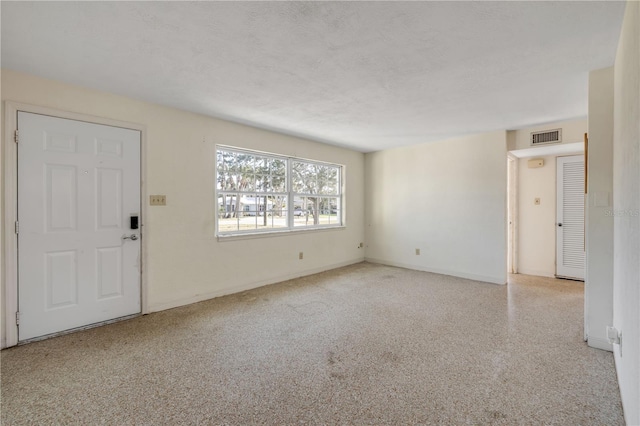 915 E 2nd Ave, New Smyrna Beach, FL 32169 - unfurnished living room featuring visible vents and baseboards