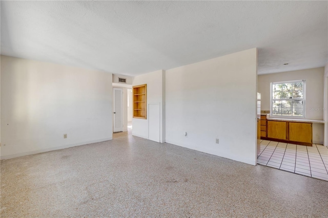 915 E 2nd Ave, New Smyrna Beach, FL 32169 - unfurnished room with visible vents, baseboards, and a textured ceiling