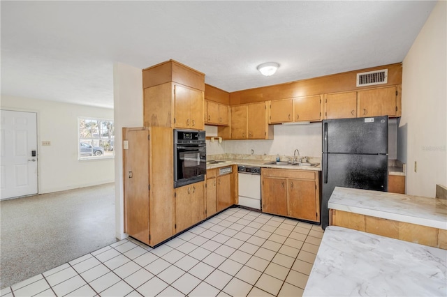 915 E 2nd Ave, New Smyrna Beach, FL 32169 - kitchen featuring light countertops, visible vents, a sink, and black appliances