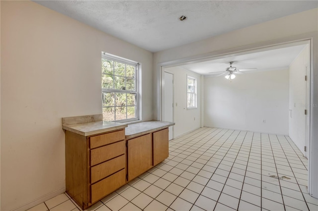 915 E 2nd Ave, New Smyrna Beach, FL 32169 - unfurnished room with light tile patterned floors, baseboards, and a ceiling fan