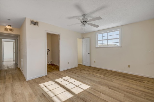 915 E 2nd Ave, New Smyrna Beach, FL 32169 - unfurnished bedroom featuring light wood-style flooring, baseboards, and visible vents