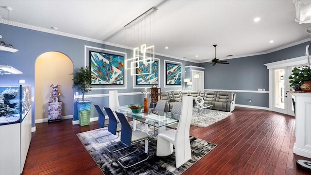 dining area featuring arched walkways, baseboards, recessed lighting, and wood finished floors