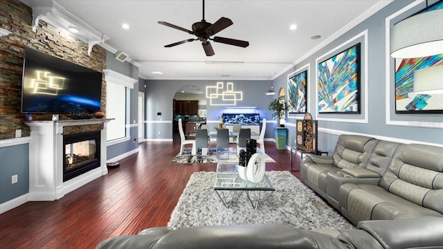 living room with crown molding, a multi sided fireplace, a ceiling fan, and wood finished floors