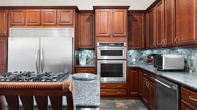 kitchen with a toaster, tasteful backsplash, and stainless steel appliances