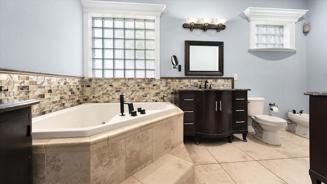 full bathroom featuring a garden tub, plenty of natural light, a bidet, and tile patterned floors