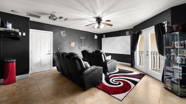 tiled cinema with french doors, a ceiling fan, a textured ceiling, and visible vents