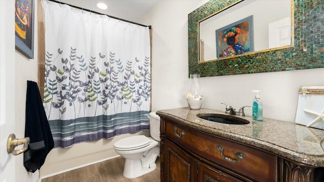 bathroom featuring vanity, wood finished floors, and toilet