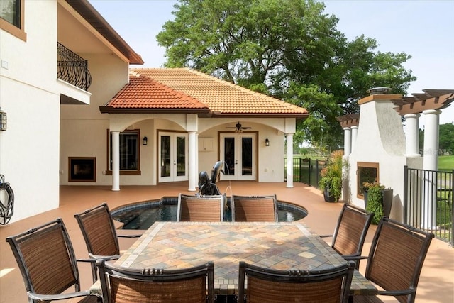 exterior space featuring a patio, outdoor dining space, french doors, and a fireplace