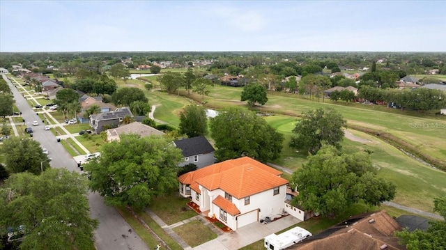 birds eye view of property featuring view of golf course and a residential view