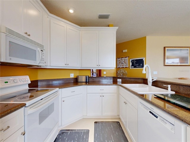 kitchen featuring a sink, white appliances, white cabinetry, visible vents, and recessed lighting