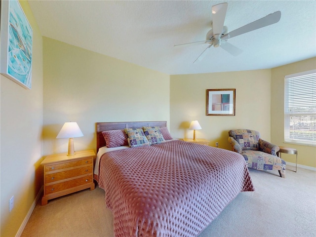 bedroom with ceiling fan, baseboards, and carpet flooring