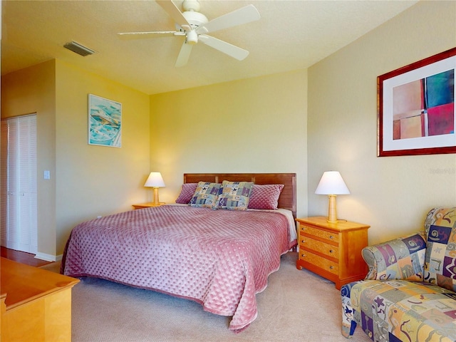 bedroom featuring visible vents, carpet flooring, and a ceiling fan