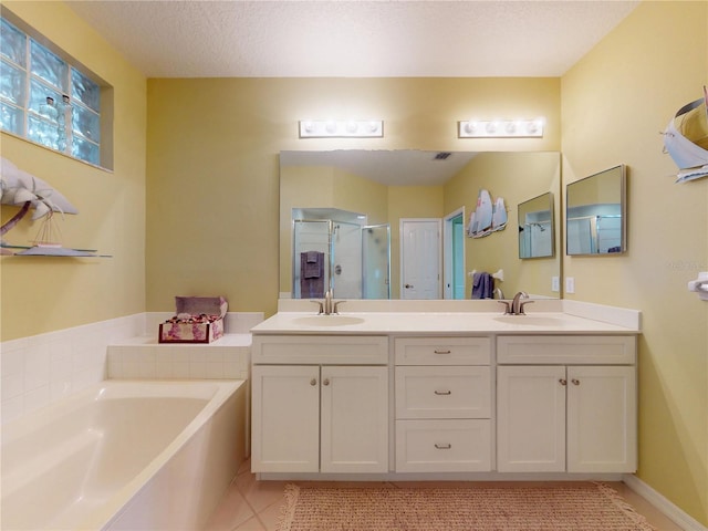 bathroom with tile patterned floors, a garden tub, a sink, and a shower stall