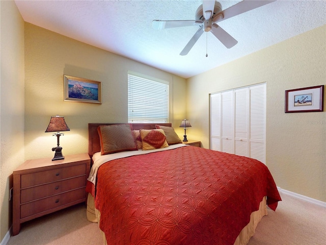 bedroom with baseboards, carpet flooring, a closet, and ceiling fan