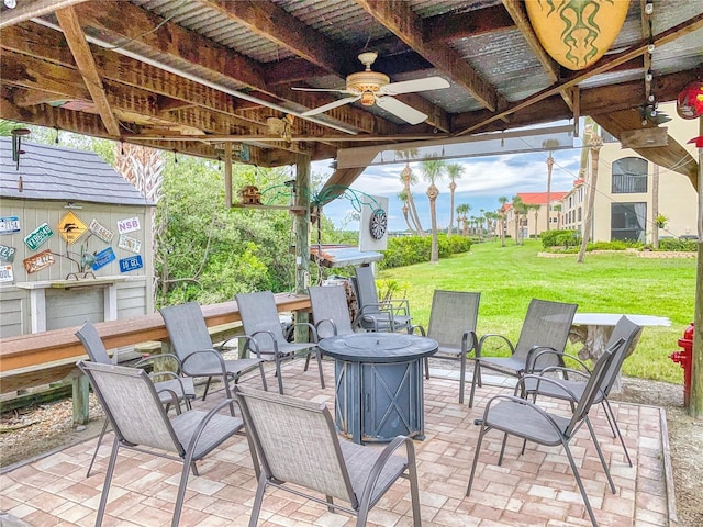 view of patio / terrace featuring a ceiling fan and an outdoor fire pit