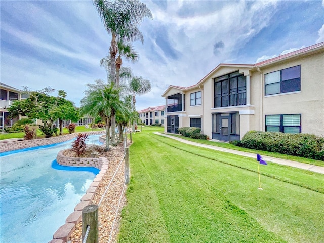 view of swimming pool featuring a lawn