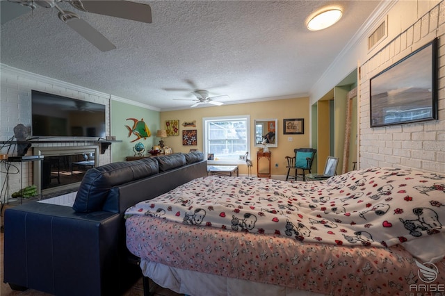 bedroom featuring a textured ceiling, visible vents, a glass covered fireplace, and ornamental molding