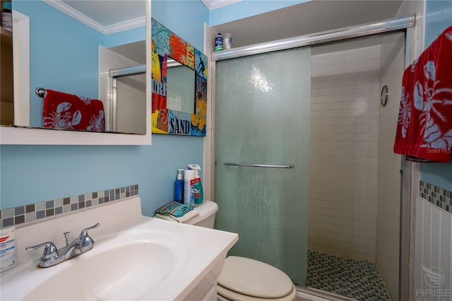 bathroom with crown molding, a shower stall, toilet, and vanity
