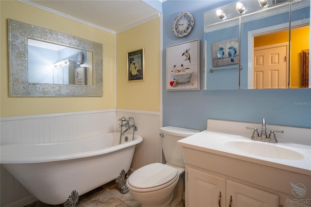 bathroom with wainscoting, a freestanding tub, vanity, toilet, and ornamental molding