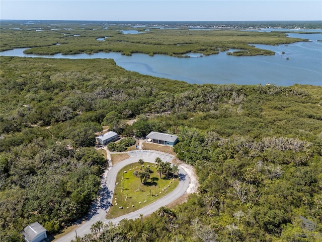 aerial view featuring a wooded view and a water view