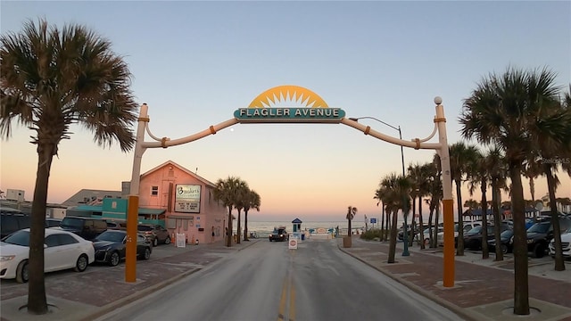 view of road with curbs, sidewalks, and a water view