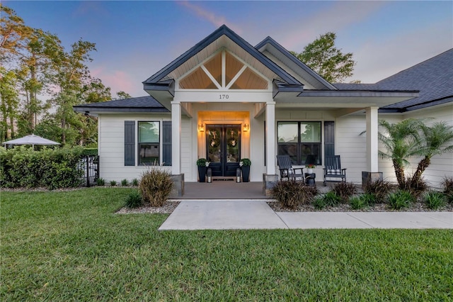 170 Live Oak Ct, New Smyrna Beach, FL 32168 - view of front of property with a porch, french doors, and a lawn