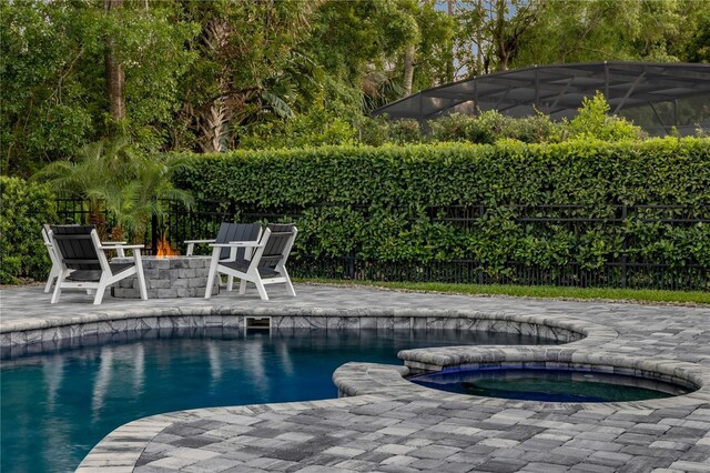 170 Live Oak Ct, New Smyrna Beach, FL 32168 - view of swimming pool with a fenced in pool, a patio, an in ground hot tub, a fire pit, and fence