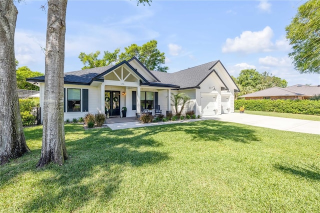 170 Live Oak Ct, New Smyrna Beach, FL 32168 - view of front of property with covered porch, a front lawn, an attached garage, a shingled roof, and driveway
