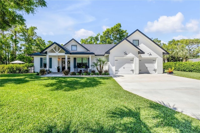 170 Live Oak Ct, New Smyrna Beach, FL 32168 - modern farmhouse style home with a front lawn, covered porch, a garage, and driveway