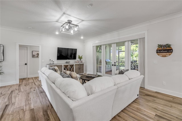 170 Live Oak Ct, New Smyrna Beach, FL 32168 - living room featuring baseboards, recessed lighting, french doors, light wood-style flooring, and crown molding