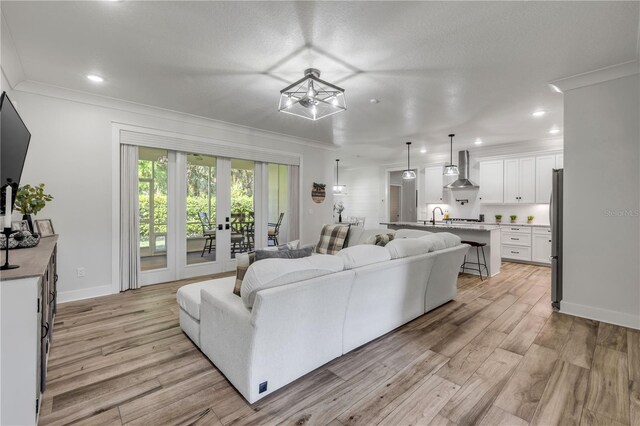 170 Live Oak Ct, New Smyrna Beach, FL 32168 - living room with crown molding, recessed lighting, and light wood-style floors