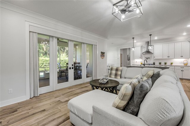 170 Live Oak Ct, New Smyrna Beach, FL 32168 - living area featuring recessed lighting, light wood finished floors, french doors, and baseboards