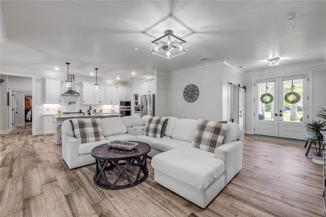 170 Live Oak Ct, New Smyrna Beach, FL 32168 - living room featuring visible vents, light wood-type flooring, a textured ceiling, crown molding, and recessed lighting