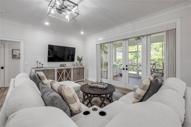 170 Live Oak Ct, New Smyrna Beach, FL 32168 - living room with light wood-style floors, crown molding, recessed lighting, french doors, and baseboards