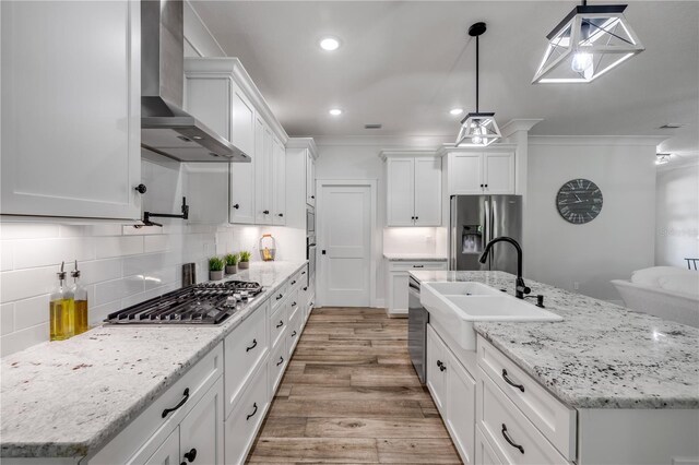 170 Live Oak Ct, New Smyrna Beach, FL 32168 - kitchen featuring crown molding, appliances with stainless steel finishes, a sink, and wall chimney range hood