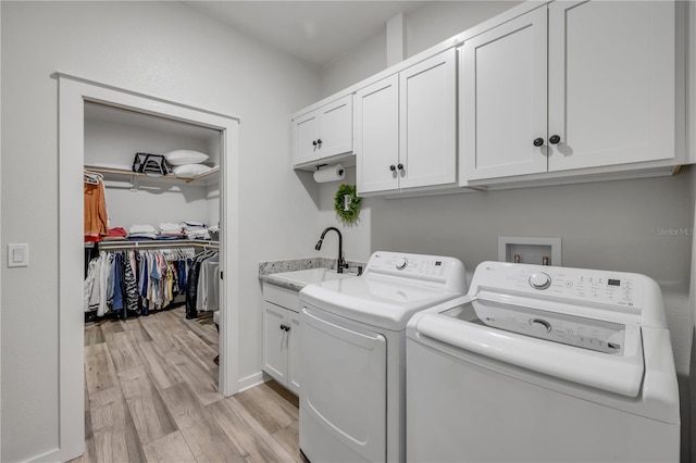 170 Live Oak Ct, New Smyrna Beach, FL 32168 - clothes washing area featuring light wood-type flooring, separate washer and dryer, a sink, and cabinet space