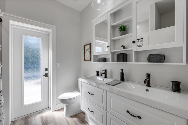 170 Live Oak Ct, New Smyrna Beach, FL 32168 - full bathroom featuring a sink, toilet, double vanity, and wood finished floors
