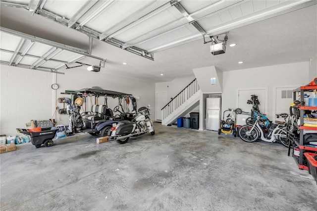 170 Live Oak Ct, New Smyrna Beach, FL 32168 - garage featuring freestanding refrigerator and a garage door opener