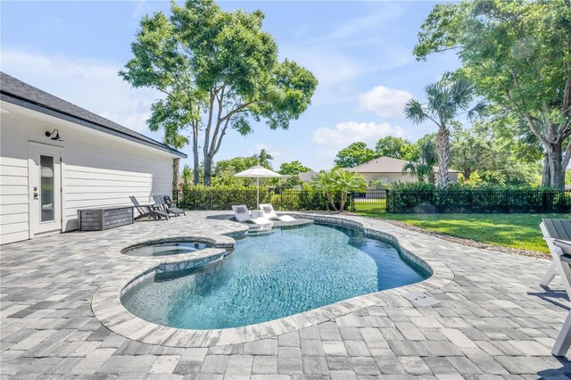 170 Live Oak Ct, New Smyrna Beach, FL 32168 - view of swimming pool featuring a patio, a fenced backyard, a pool with connected hot tub, and a lawn