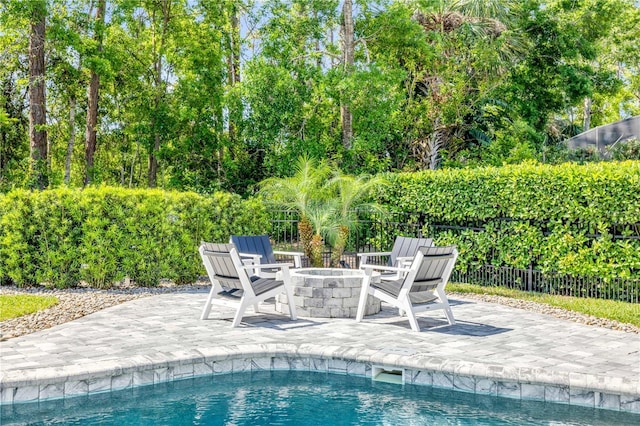 170 Live Oak Ct, New Smyrna Beach, FL 32168 - view of swimming pool featuring a patio, fence, a fenced in pool, and a fire pit