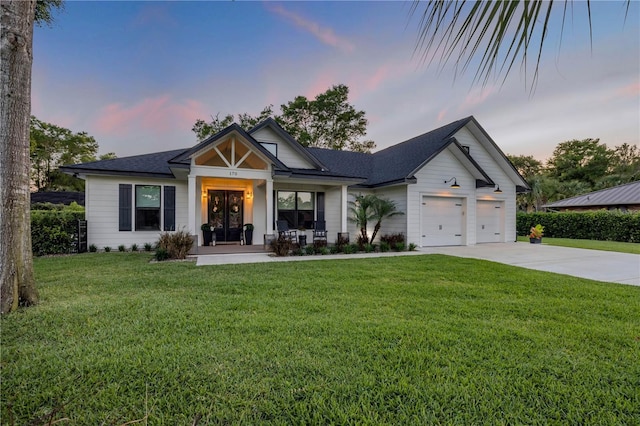 170 Live Oak Ct, New Smyrna Beach, FL 32168 - view of front of house featuring an attached garage, a yard, concrete driveway, and covered porch