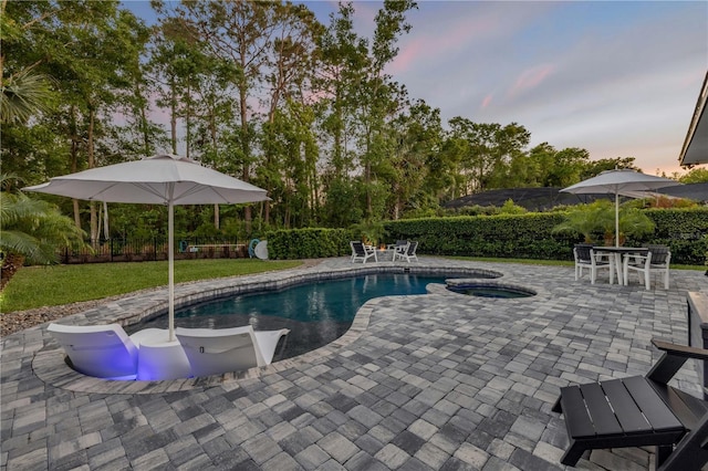 170 Live Oak Ct, New Smyrna Beach, FL 32168 - pool at dusk with a fenced in pool, a patio, fence, and an in ground hot tub